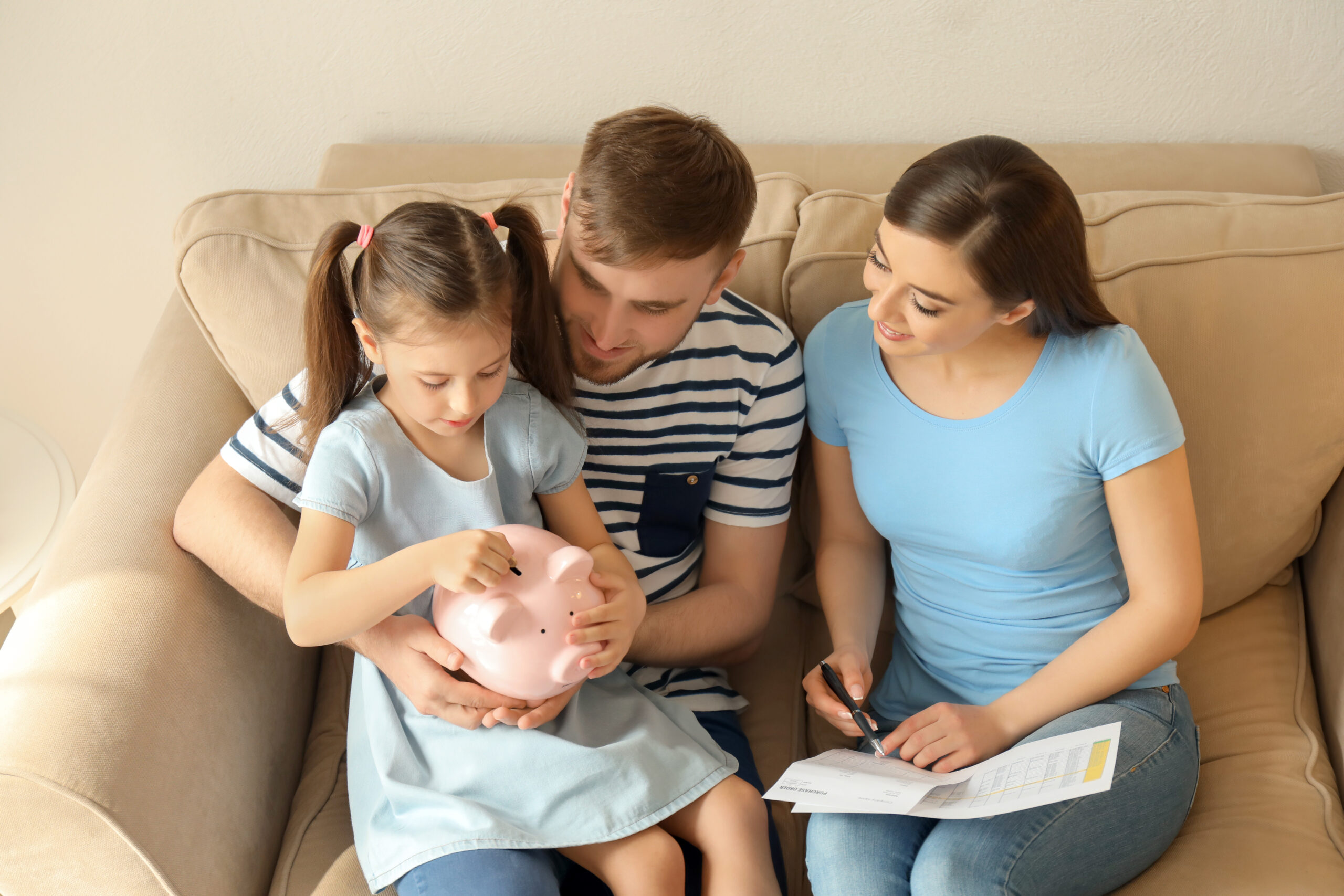 Young family with a piggy bank and financial documents